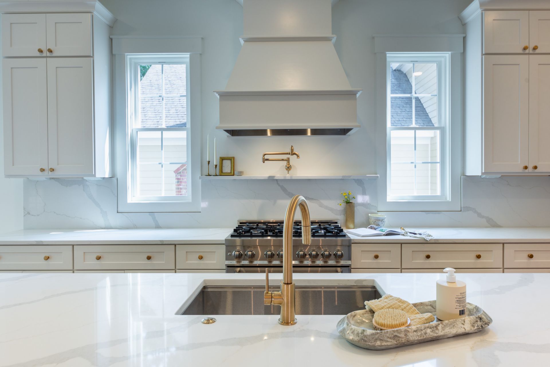 Worlington — white kitchen with marble backsplash and brass fixtures